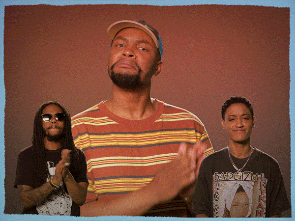 Celebrity gif. Larger cutout of Steve Lacy claps delicately in between small cutouts of Patrick Paige II and Syd, who clap, give thumbs ups and point at us.