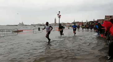Venice Marathon Runners Run Through Flooded Street