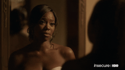 TV gif. Yvonne Orji as Molly in "Insecure" nods slowly and looks emotional toward Issa Rae as Issa, who also appears tearful.