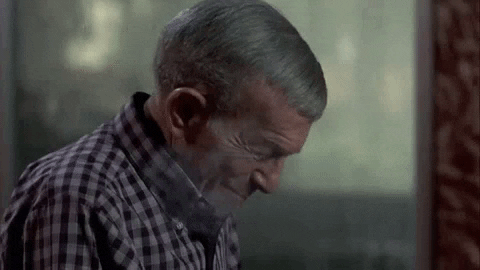 Movie gif. In a scene from Oh God! You Devil, an entertained George Burns wears a plaid flannel shirt and looks down. As a bit of smoke dissipates around him, he says: Text, "I love to scare the hell out of people."