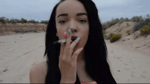 pretty cannabis smoker in the desert GIF