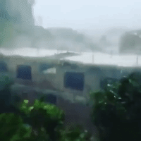 Wind Rips Metal Sheeting off Roofs as Typhoon Doksuri Hits Vietnam