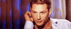 Celebrity gif. Tom Hardy looks up at us with a sexy gaze as he holds his hand near his ear. He then winks at us flirtatiously.