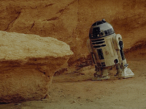 Star Wars gif. R2-D2 tips over, face planting into the ground.