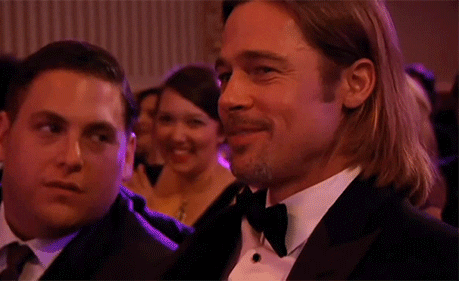 Celebrity gif. Brad Pitt looks at us and blows a grateful kiss. 