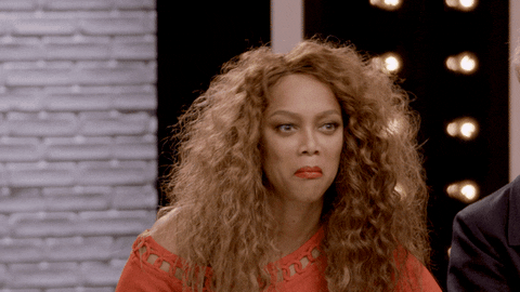 Celebrity gif. An incredulous Tyra Banks puts up both hands and looks around in confusion.