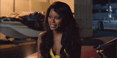 Movie gif. Taylour Page as Zola in Zola smiles nervously and widens her eyes with concern.