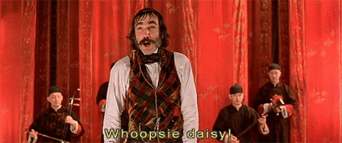 Movie gif. Daniel Day-Lewis as Bill the Butcher in Gangs of New York stands on stage, throwing up his hands and says sarcastically, “whoopsie daisy!