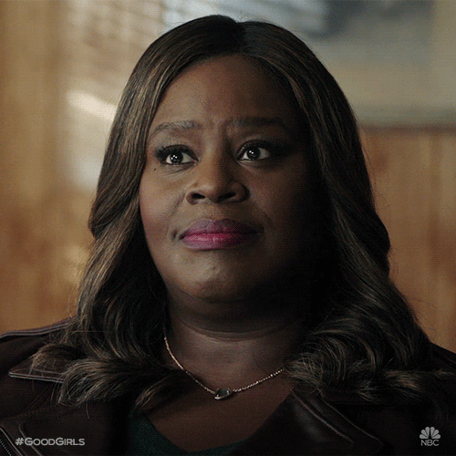TV gif. Closeup of Retta as Ruby in The Good Girls as she tilts her head, purses her lips, and rolls her eyes to the side.