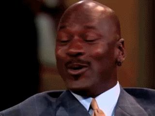 Reality TV gif. Michael Jordan on The Oprah Winfrey Show winces as if holding in laughter, and then laughs so hard that he has to catch his breath.