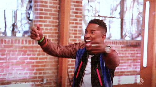 Video gif. A contestant on NBC's World of Dance show jubilantly shimmys across a room.
