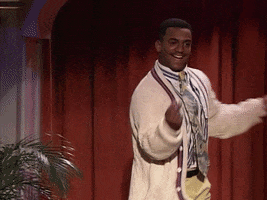 TV gif. Alfonso Ribeiro as Carlton in the Fresh Prince of Bel-Air does "the Carlton" dance, snapping his fingers and swinging his arms left and right, on a stage in front of a red curtain.