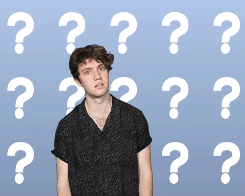Celebrity gif. Noah from the band Echosmith looks confused as he raises his hands up and stares at us, wide eyed. The background is filled with white question marks.