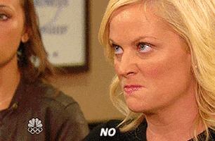 Parks and Recreation gif. Amy Poehler as Leslie scrunches her face in anger before barking the word "No!"