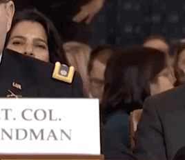 Political gif. A woman in the audience during the impeachment inquiry is drinking from a to go coffee cup and she tries to get every last sip out from the cup, tilting herself and the cup backwards.