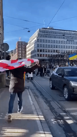 Crowd Sings Ukrainian National Anthem at Anti-War Protest in Stockholm