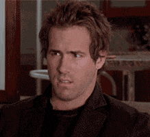 Movie gif. Ryan Reynolds as Chris in Just Friends sits on a sofa in bewildered confusion. He looks up as if searching for clarity on the ceiling.