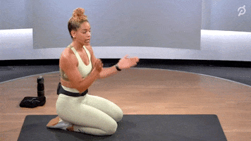 Ad gif. Ad for Peloton. An instructor is clapping and goes on all fours on a yoga mat, saying, "Clap it up, clap it up!"
