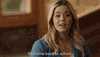 TV gif. An excited Sasha Pieterse as Alison on Pretty Little Liars looks around and says, “Welcome back to school.”