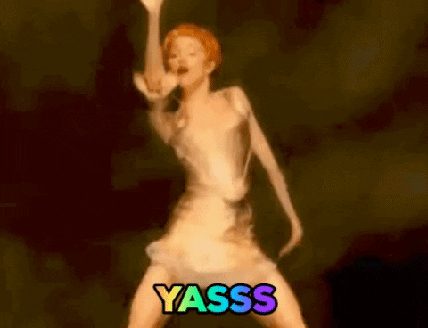 Music video gif. Madonna in the video for Fever shakes her hips and whirls her arms while wearing a metallic corset and mini skirt. Text, "Yasss."