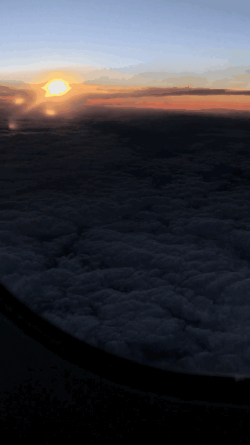 sunset flying GIF