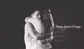 Video gif. A black-and-white scene of a man and a woman hugging tenderly. The woman runs her hand through the man's hair. Text, "These kind of hugs [sic]."
