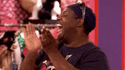 Reality TV gif. Latrice Royale and Trinity the Tuck on RuPaul’s Drag Race All Stars turn towards each other and high five, grinning in excitement.