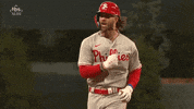 Sports gif. Bryce Harper of the Phillies in a jersey and batter's helmet running in slow motion as he yells with excitement. 