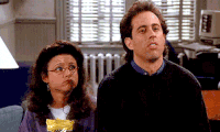 Seinfeld gif. Jerry Seinfeld as Jerry and Julia Louis-Dreyfus as Elaine give us synchronous shrugs that seem to say "I don't know and I don't care."