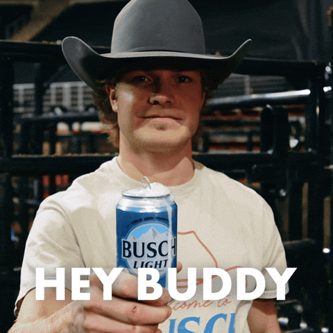 Sponsored gif. Man wearing a cowboy hat offers a foaming can of Busch Light beer. Text reads, “Hey buddy.”