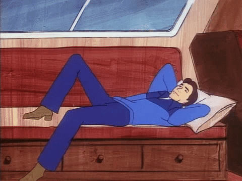 Cartoon gif. Hanna-Barbera's Devlin lays back on a couch, one knee up, arms behind his head, thoughtfully staring into space.