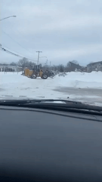 Wheel Loader Clears Vehicle Surrounded by Snow in Buffalo