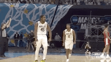Sports gif. Davion Mitchell of the Baylor Bears jumps excitedly while pumping his arms, like a bomb exploding. Text, "boom."