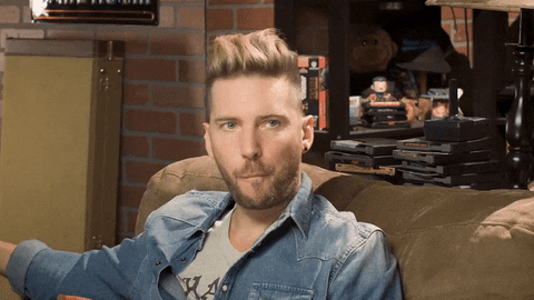 RETROREPLAY giphyupload whatever shrug troy baker GIF