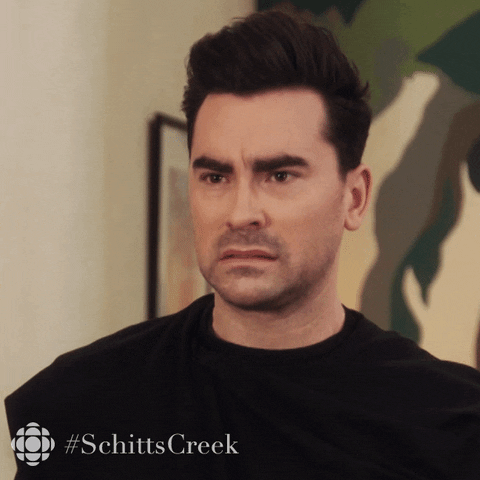 Schitt’s Creek gif. A confused Dan Levy as David squints his eyes as if he is trying to understand something.