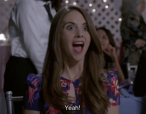 TV gif. Allison Brie as Annie on Community. She's ecstatic and her eyes and mouth go wide as she eagerly leans forward and says, "Yeah!"