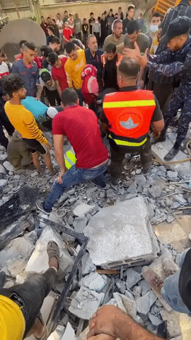 Rescuers and Digger Search Rubble for Victims of Airstrike in Gaza