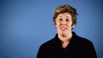 Political gif. Sally Kohn shrugs and scrunches her nose while saying, "Sorry," nonchalantly.