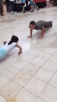 Little Girl Competes Against Marine Cadet at Push Up Challenge