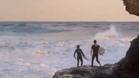 Surfer Collides With Rocks After Getting Struck by a Huge Wave