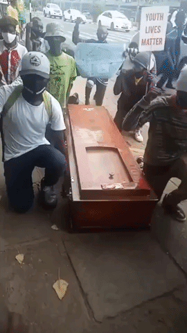 Demonstrators Take a Knee Next to Casket to Protest Police Brutality in Nairobi