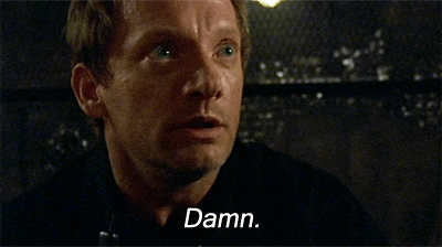 TV gif. Douglas Henshall as Nick Cutter in Primeval looks completely stunned, staring at something with wide eyes while saying, "Damn," which appears as text.