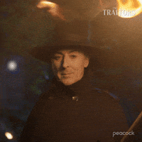 Sponsored gif. Alan Cumming as host of The Traitors in a black coat and matching wide-brimmed hat says, “I sincerely hope not,” while holding a burning torch. Text also reads, “I sincerely hope not.”