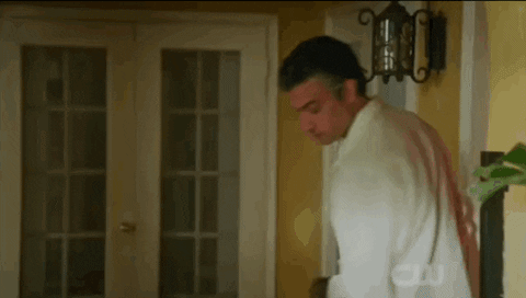 TV gif. Brett Dier and Jaime Camil as Michael Cordero Jr. and Rogelio de la Vega in Jane the Virgin cheerfully greet each other with a special handshake that consists of two high fives and a fist bump ending with an animated "poof."