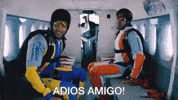 Movie gif. Farhan Akhtar as Imraan and Hrithik Roshan as Arjun in Zindagi Na Milegi Dobara sit in a plane wearing skydiving gear as Imraan shouts in Spanish, "Adios amigo!"