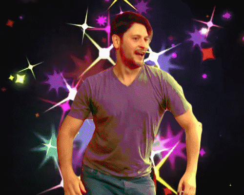 Video gif. Man does an awkwardly jerky shoulder dance in place with his mouth hanging open in front of a digitized starry, glittery background.