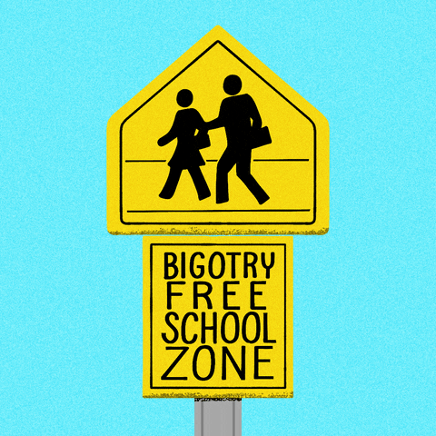 Digital art gif. Yellow pedestrian crossing sign featuring two figures crossing the road against a light blue background. Below a square yellow sign reads, “Bigotry free school zone.”