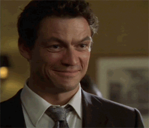 TV gif. An amused Dominic West as Jimmy on The Wire looks up and down, then chuckles.