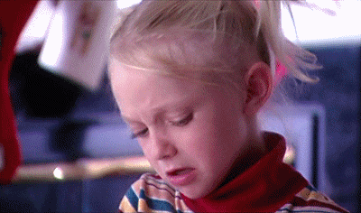 Movie gif. Young Dakota Fanning as Clairee in Father Xmas with two pigtails and a colorful turtleneck shakes her head and scrunches up her face in disgust.
