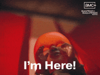 Sponsored gif. Evil puppet baby throws its arms wide. It’s backlit by a sinister red light. Text reads, “I’m here!” In the upper right corner is the logo for AMC's Halfway to Halloween Month, streaming on Shudder.